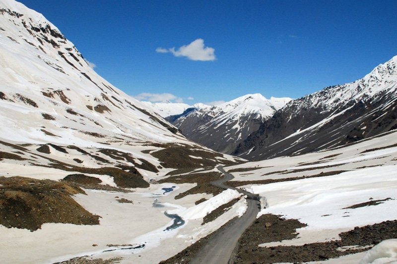 White sedan taxi on a Himalayan highway