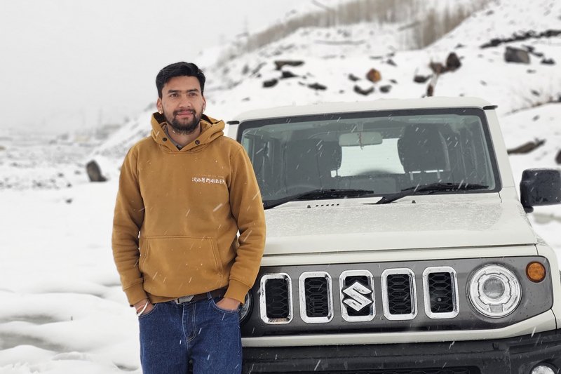 White sedan taxi on a Himalayan highway