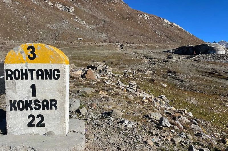 White sedan taxi on a Himachal road
